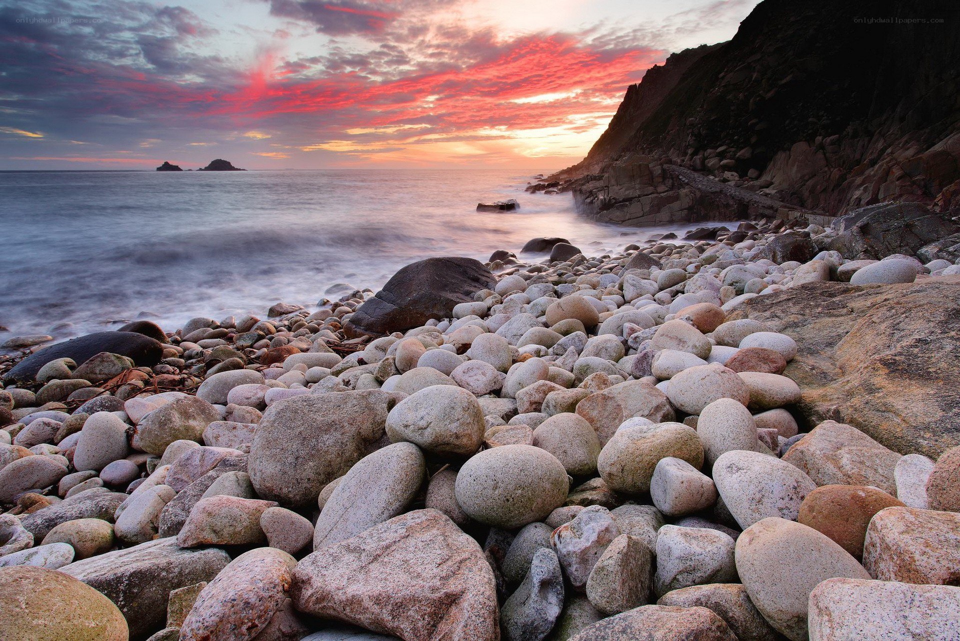 Sunset over rocky beach