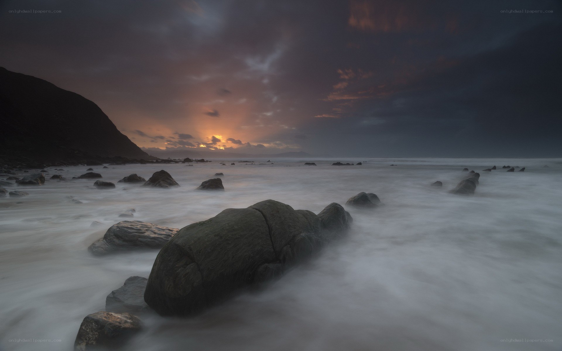 Sunset over rocky beach