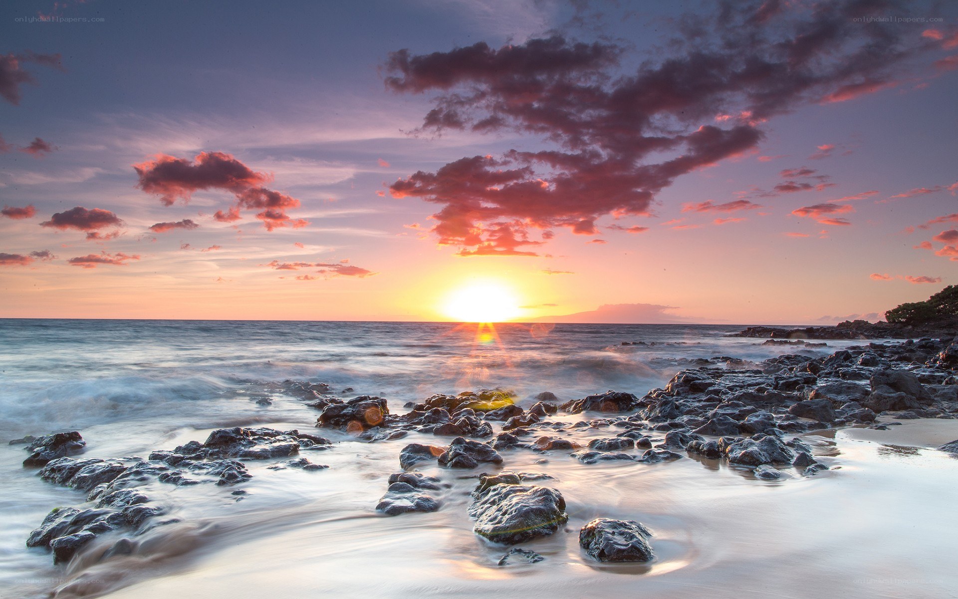 Sunset over rocky beach