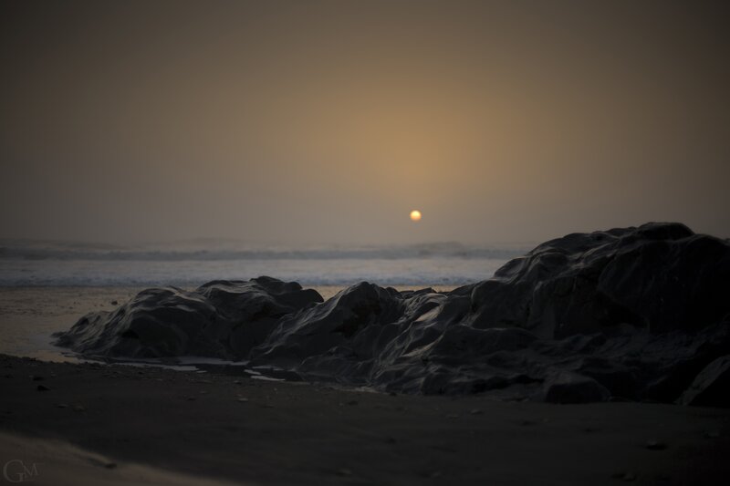 Sunset over rocky beach