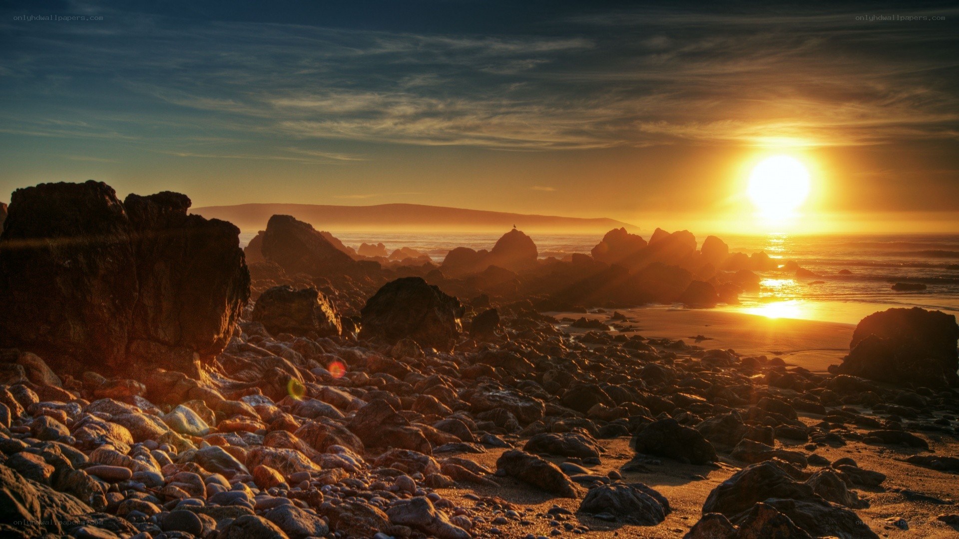 Sunset over rocky beach