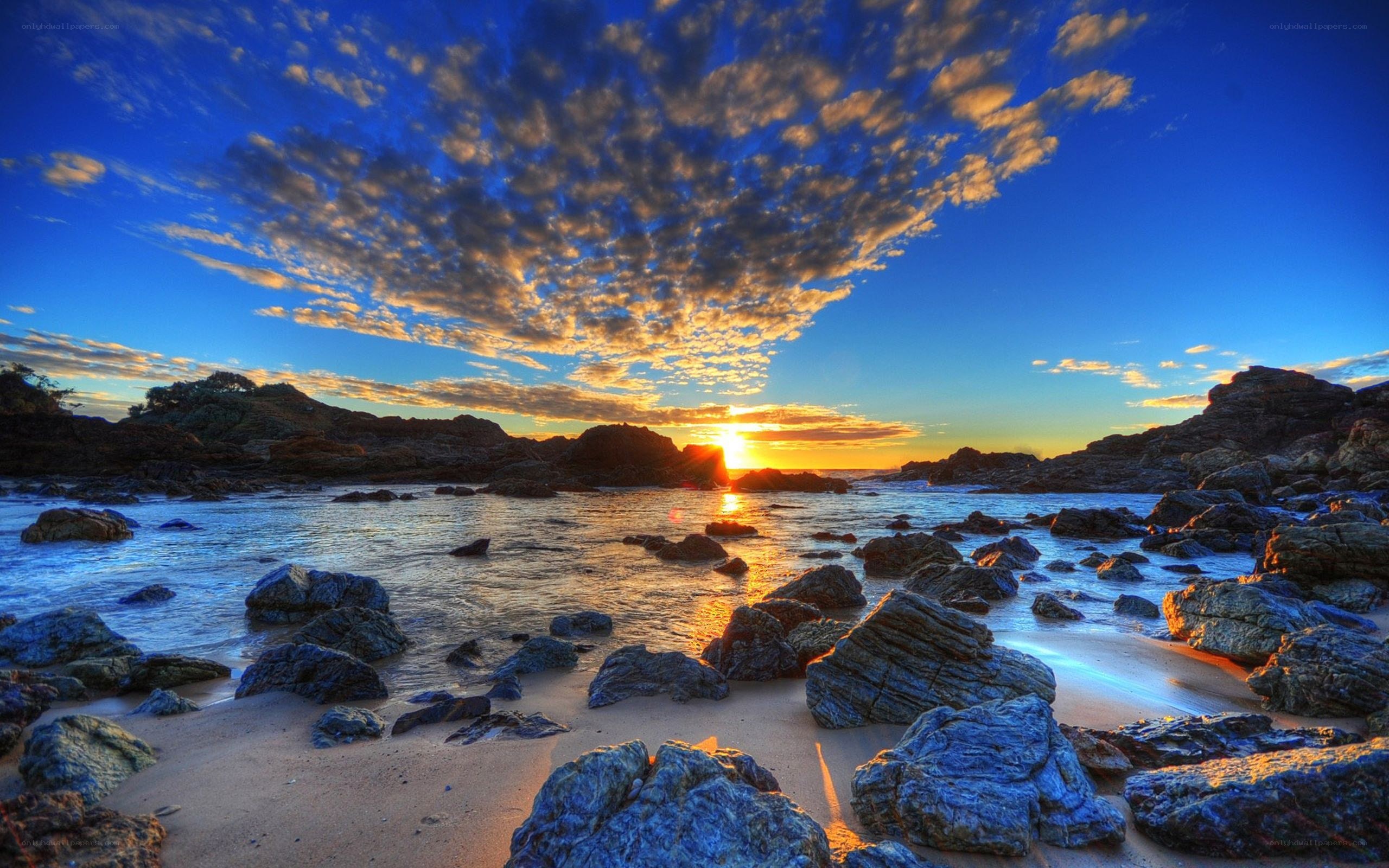 Sunset over rocky beach