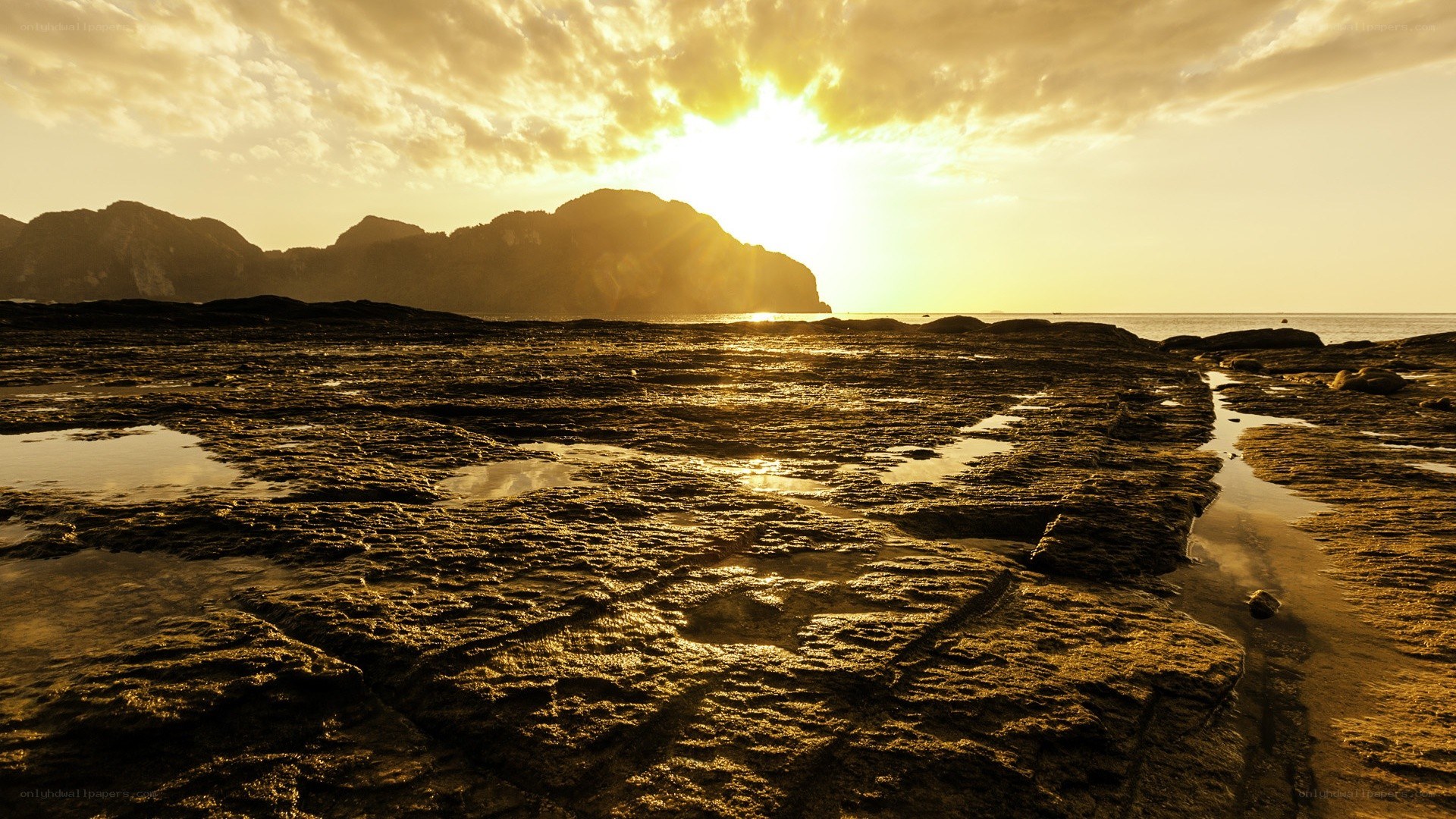 Sunset over rocky beach