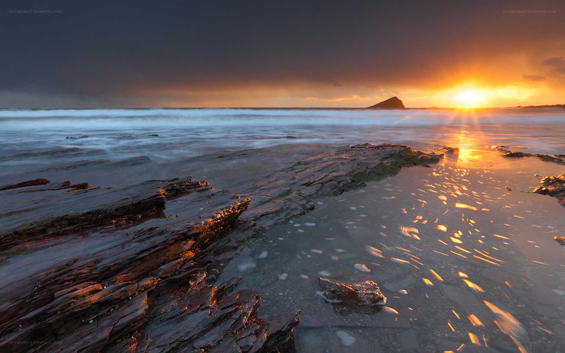 Sunset over rocky beach