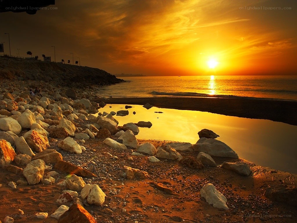 Sunset over rocky beach