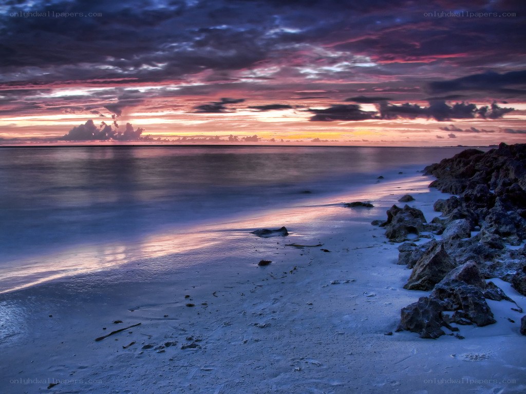 sunset over rocky beach