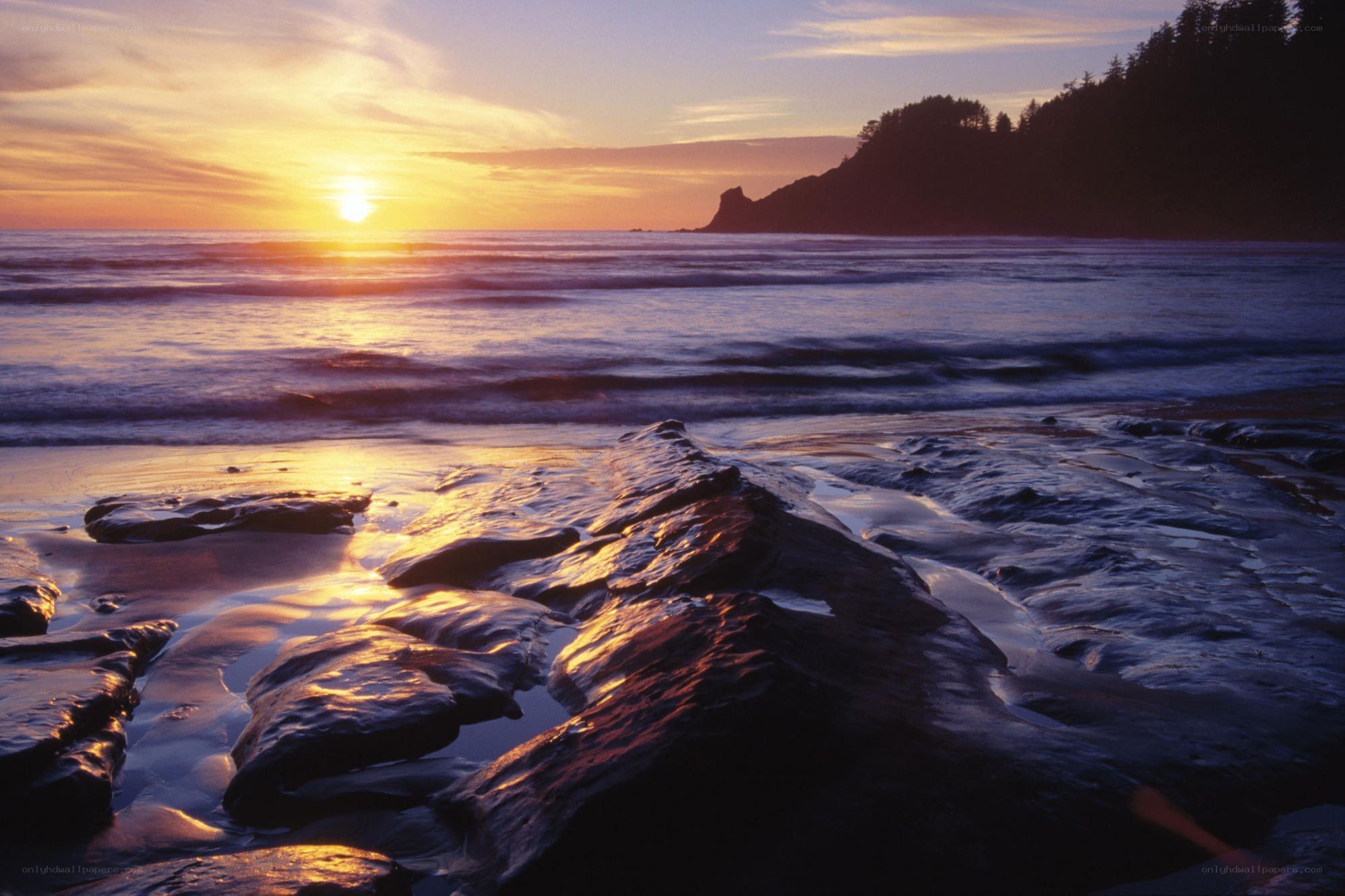 sunset over rocky beach