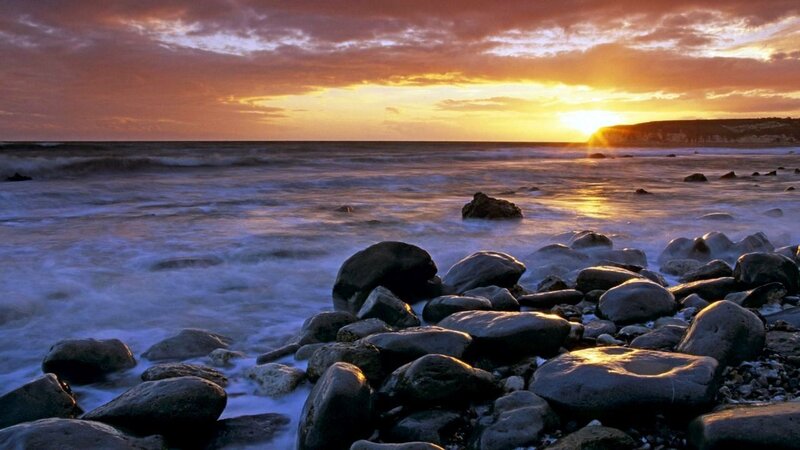 Sunset over rocky beach