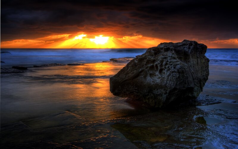 Sunset over rocky beach