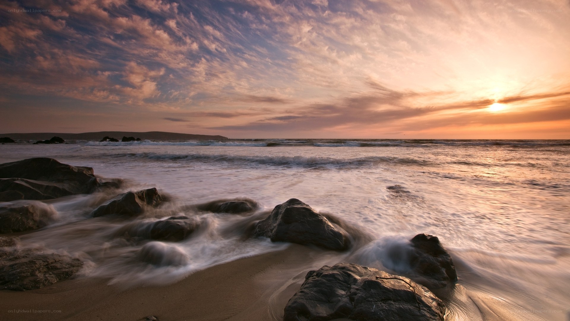 Sunset over rocky beach