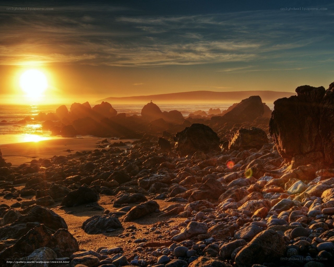 Sunset over rocky beach