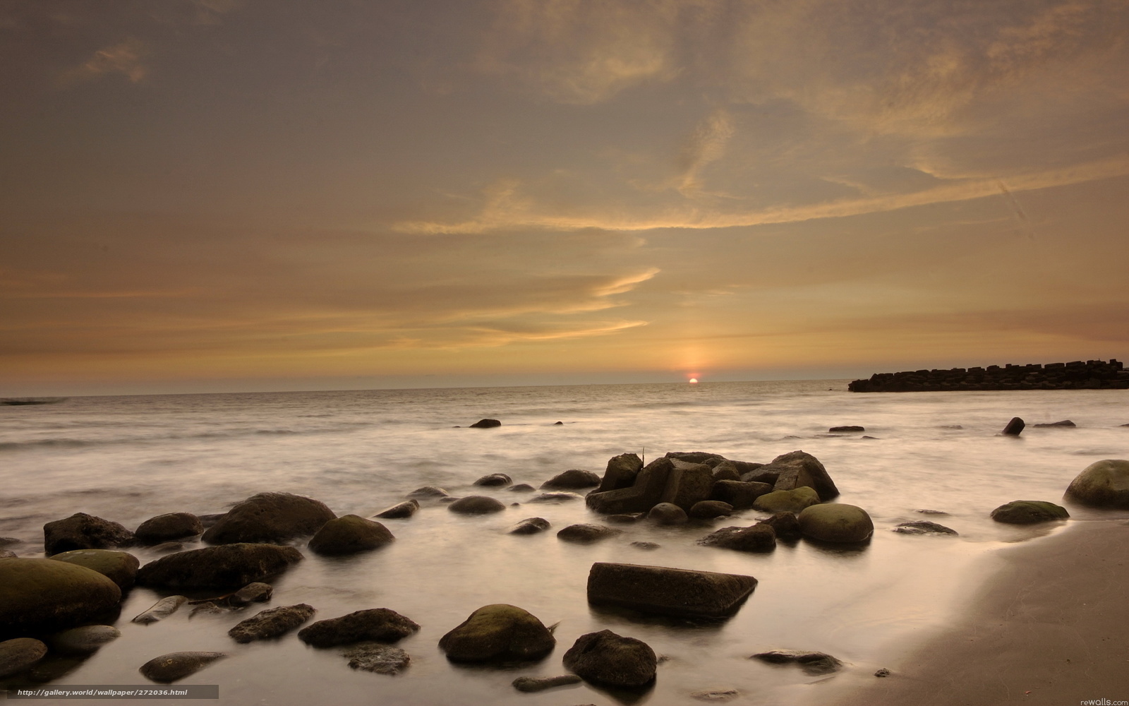 Sunset over rocky beach