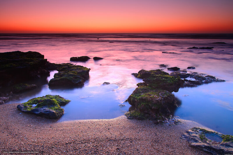 Sunset over rocky beach