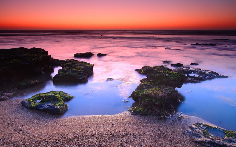 Sunset over rocky beach