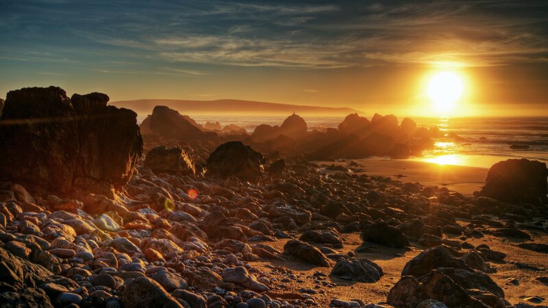 Sunset over rocky beach
