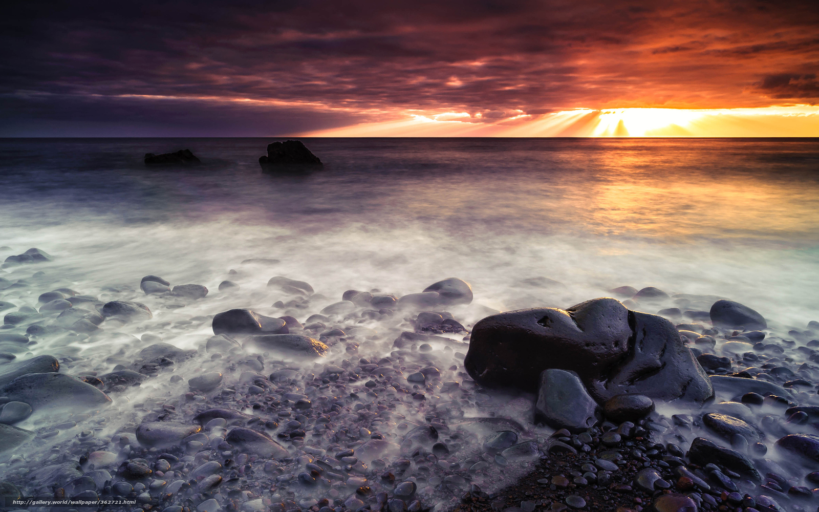Sunset over rocky beach