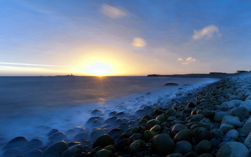 Sunset over rocky beach