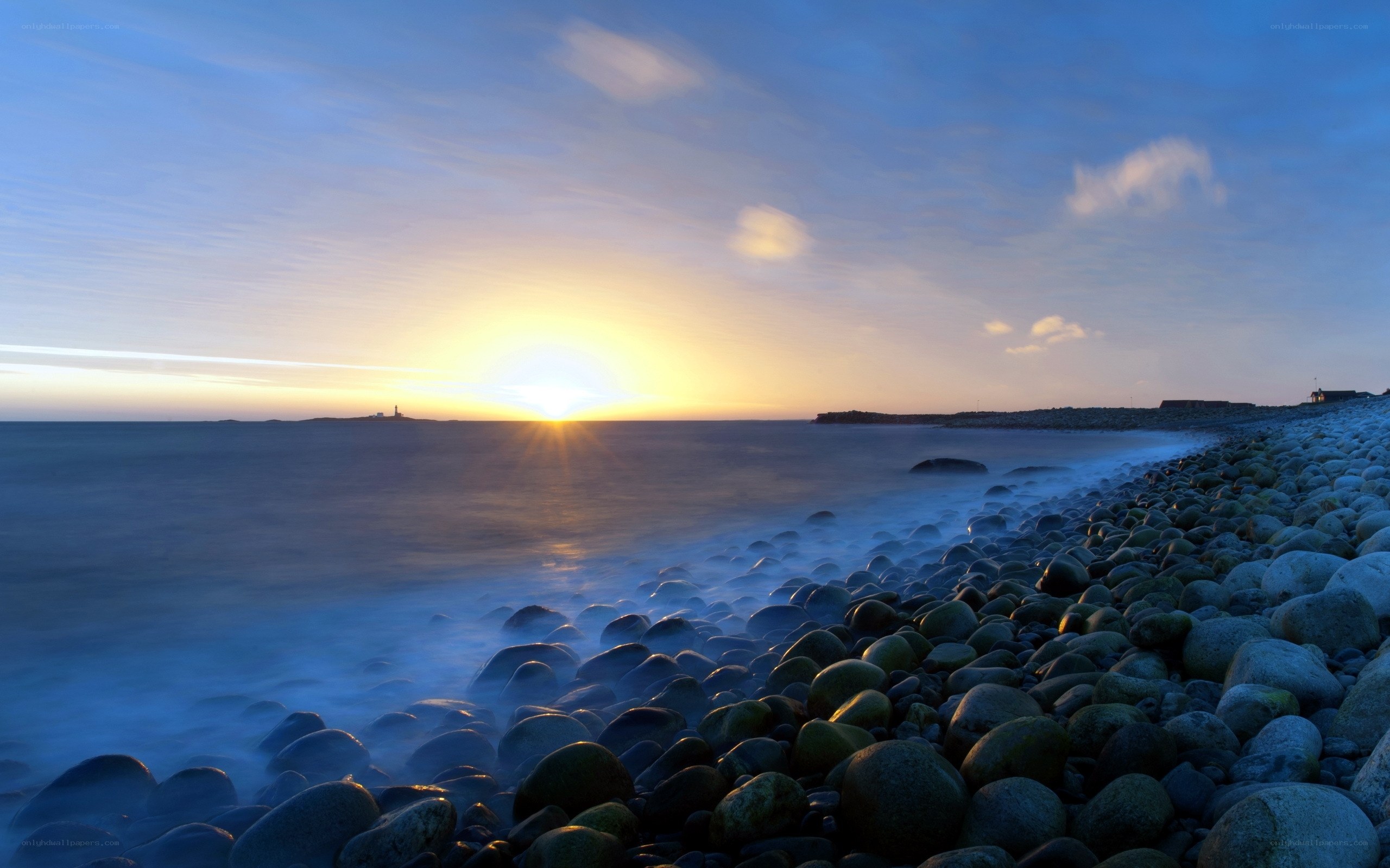 Sunset over rocky beach