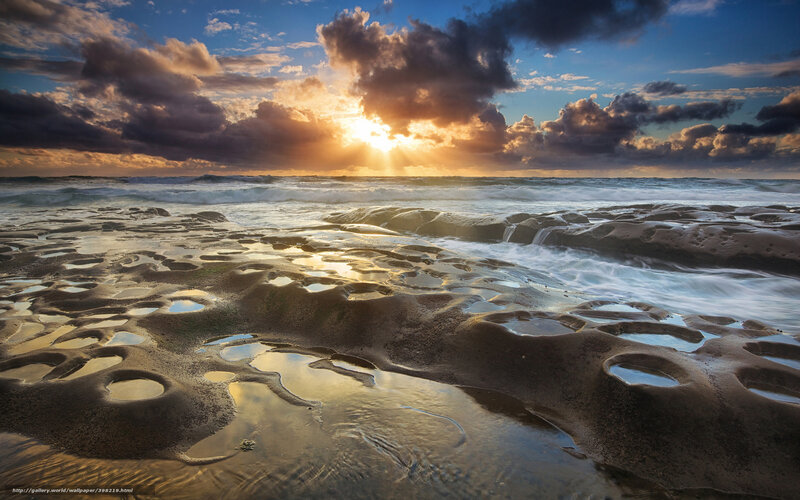 Sunset over rocky beach