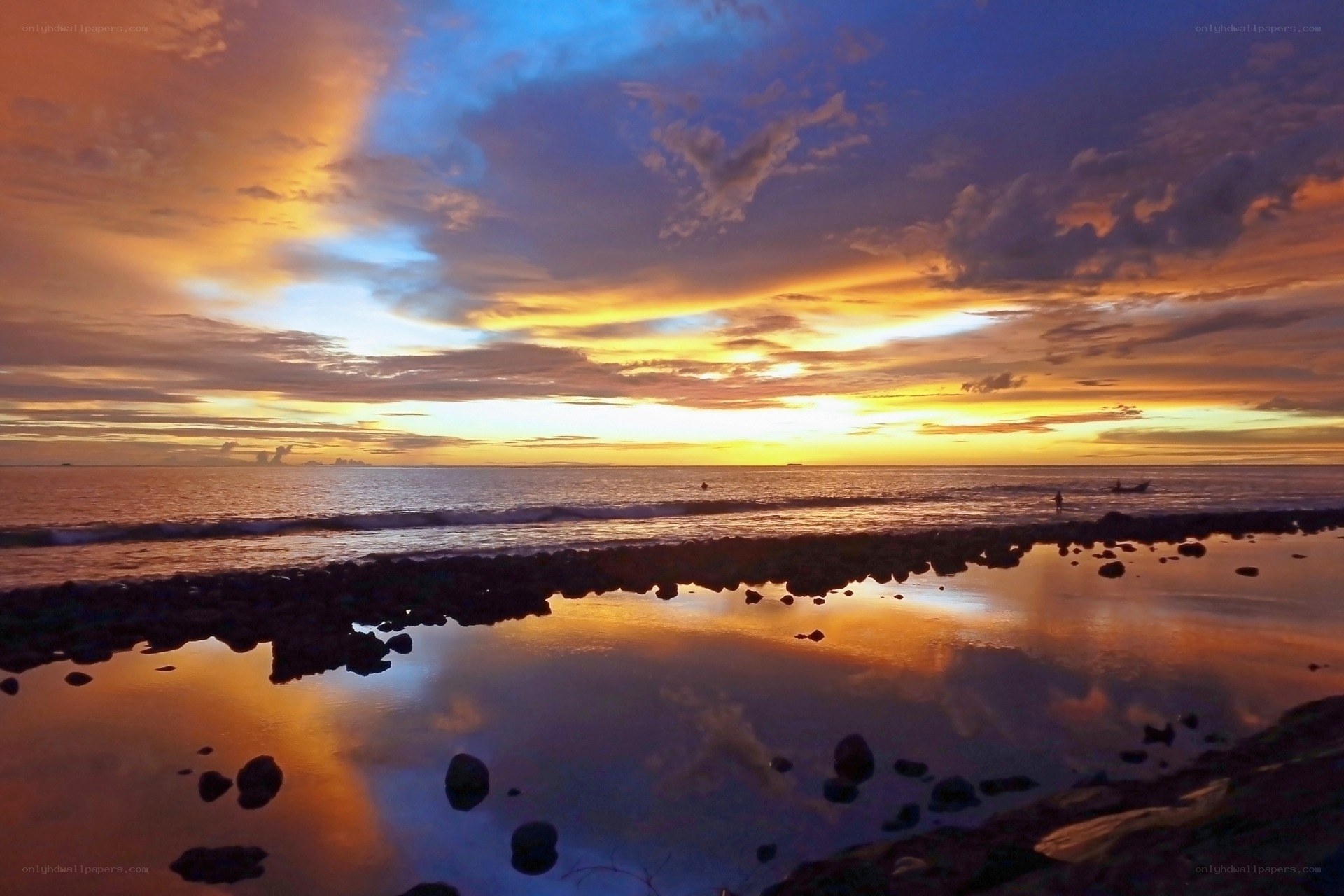 Sunset over rocky beach