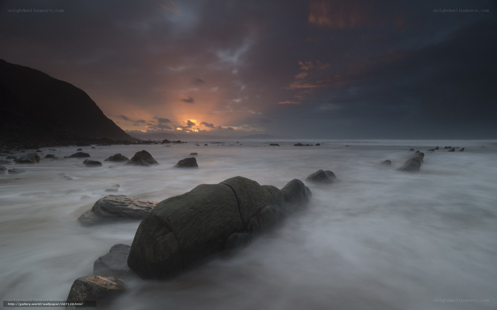 Sunset over rocky beach