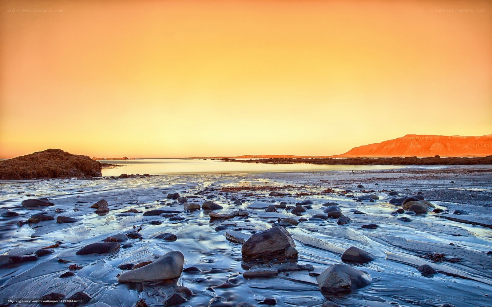 Sunset over rocky beach