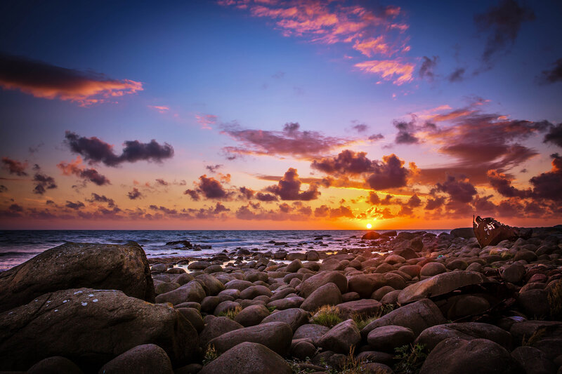 Sunset over Rocky Beach — Blue, Dramatic, Photograph, Sun, Clouds