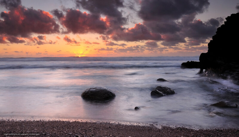 Sunset over Rocky Beach — Orange, Dramatic, Photograph, Rocks, Ocean, Clouds, Sand