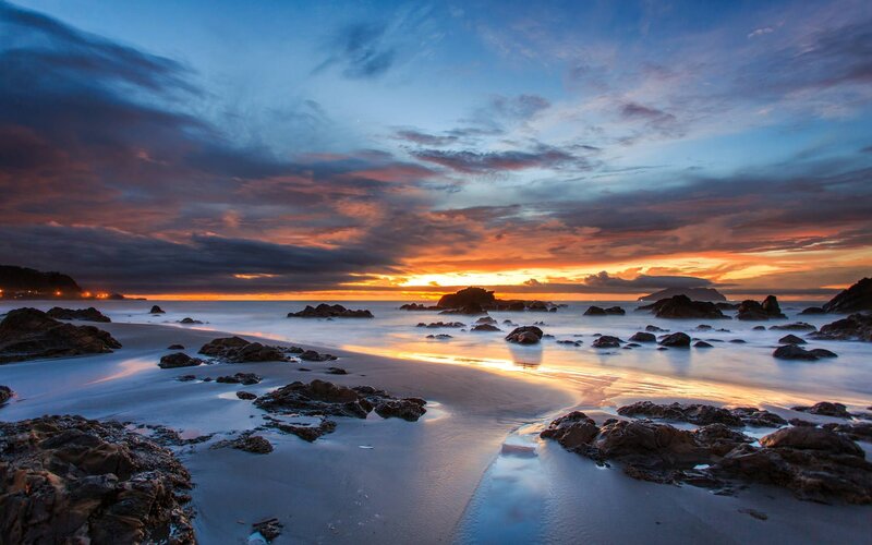 Sunset over Rocky Beach — Orange, Dramatic, Photograph, Rocks, Ocean, Sky, Clouds