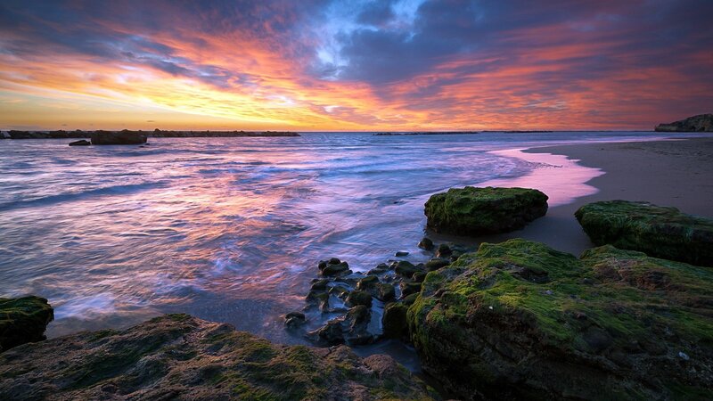 Sunset over Rocky Beach — Orange, Dramatic, Photograph, Rocks, Ocean, Sky, Sand
