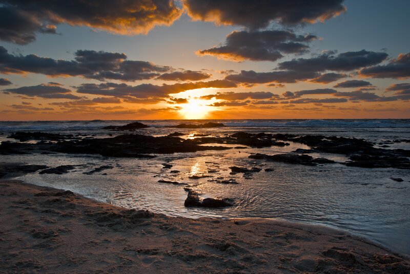 Sunset over Rocky Beach — Orange, Dramatic, Photograph, Sun, Clouds, Ocean, Rocks
