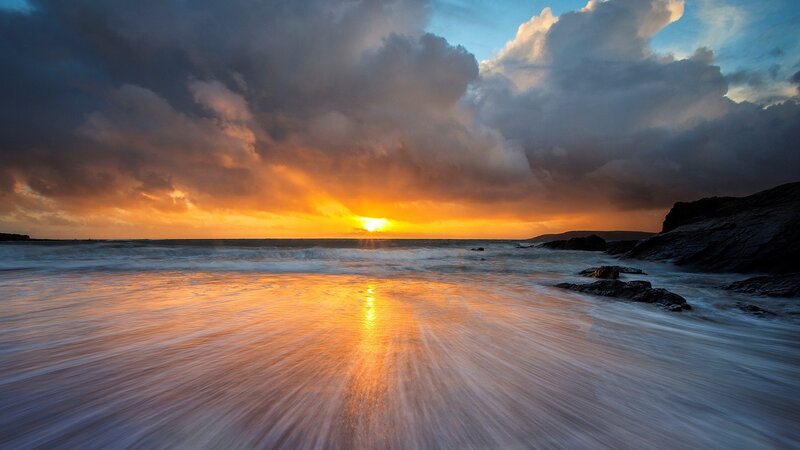 Sunset over Rocky Beach — Orange, Dramatic, Photograph, Sun, Clouds, Ocean