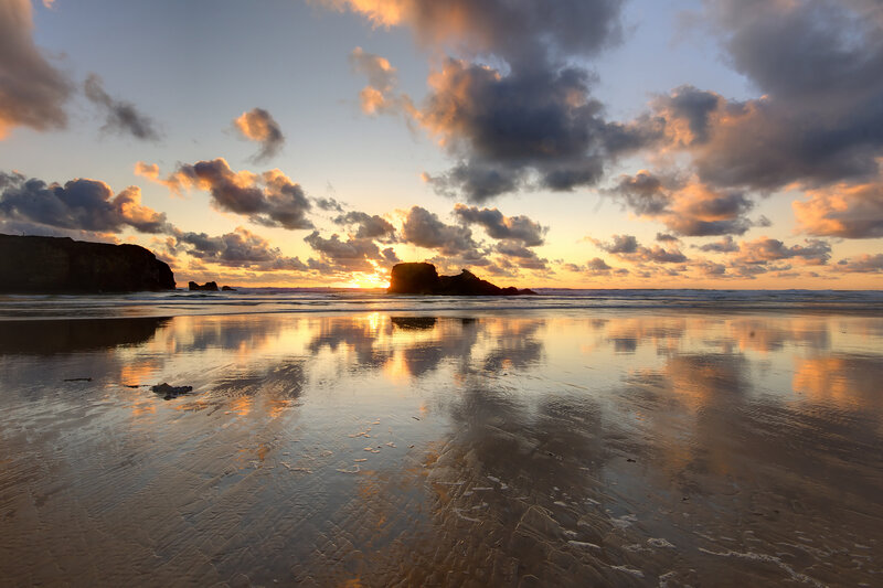 Sunset over Rocky Beach — Orange, Serene, Photograph, Clouds
