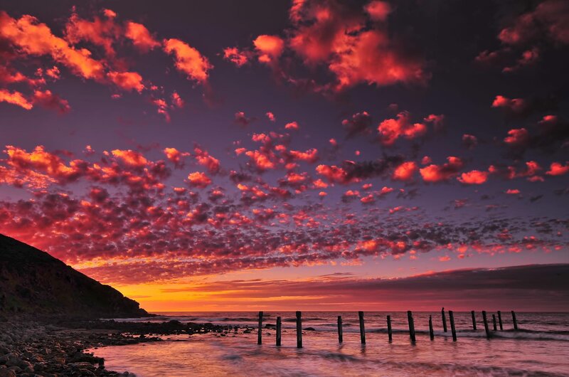 Sunset over Rocky Beach — Red, Dramatic, Photograph, Clouds