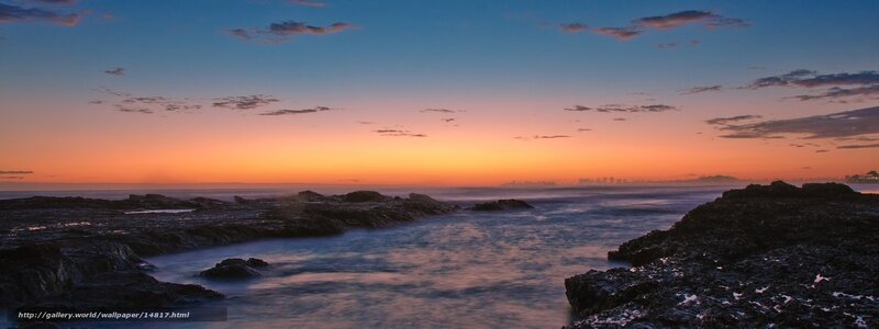 sunset over rocky coastline