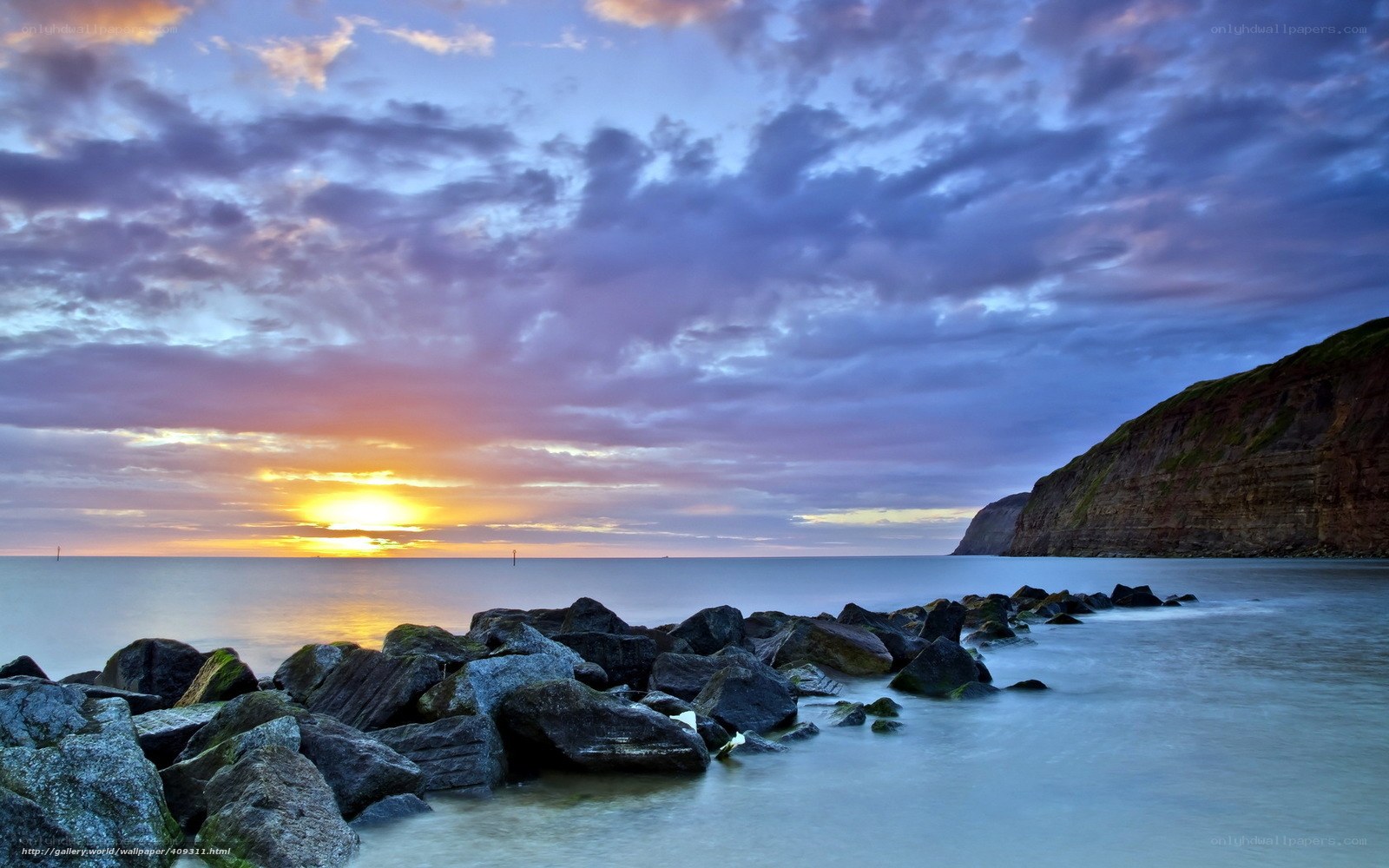 Sunset over rocky coastline