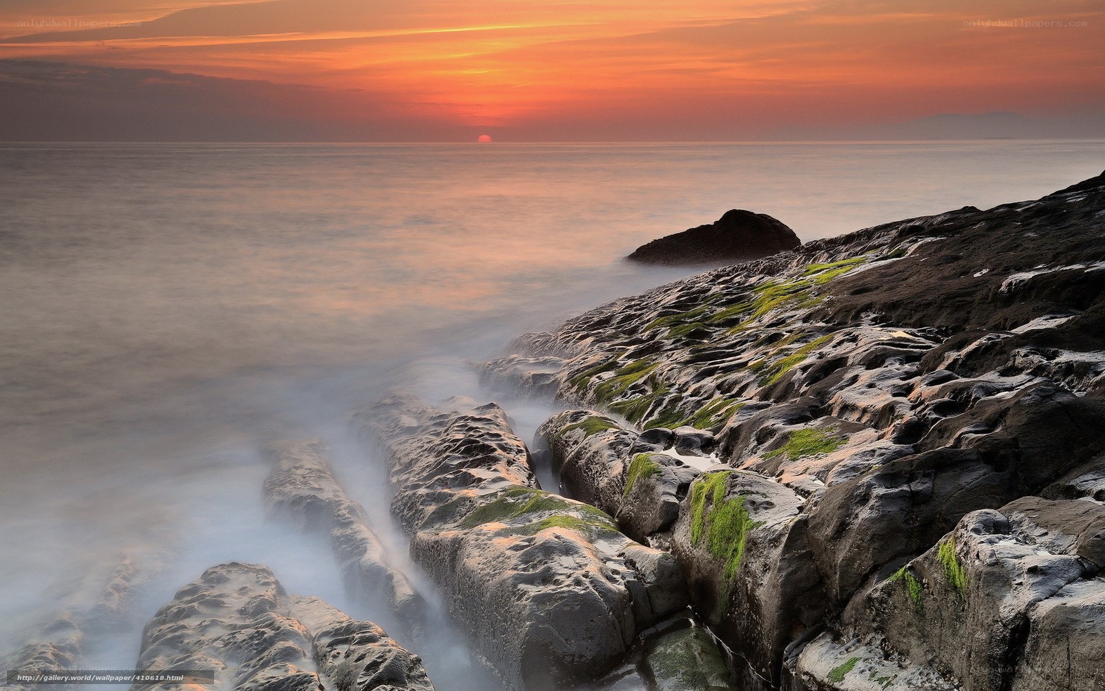 Sunset over rocky coastline