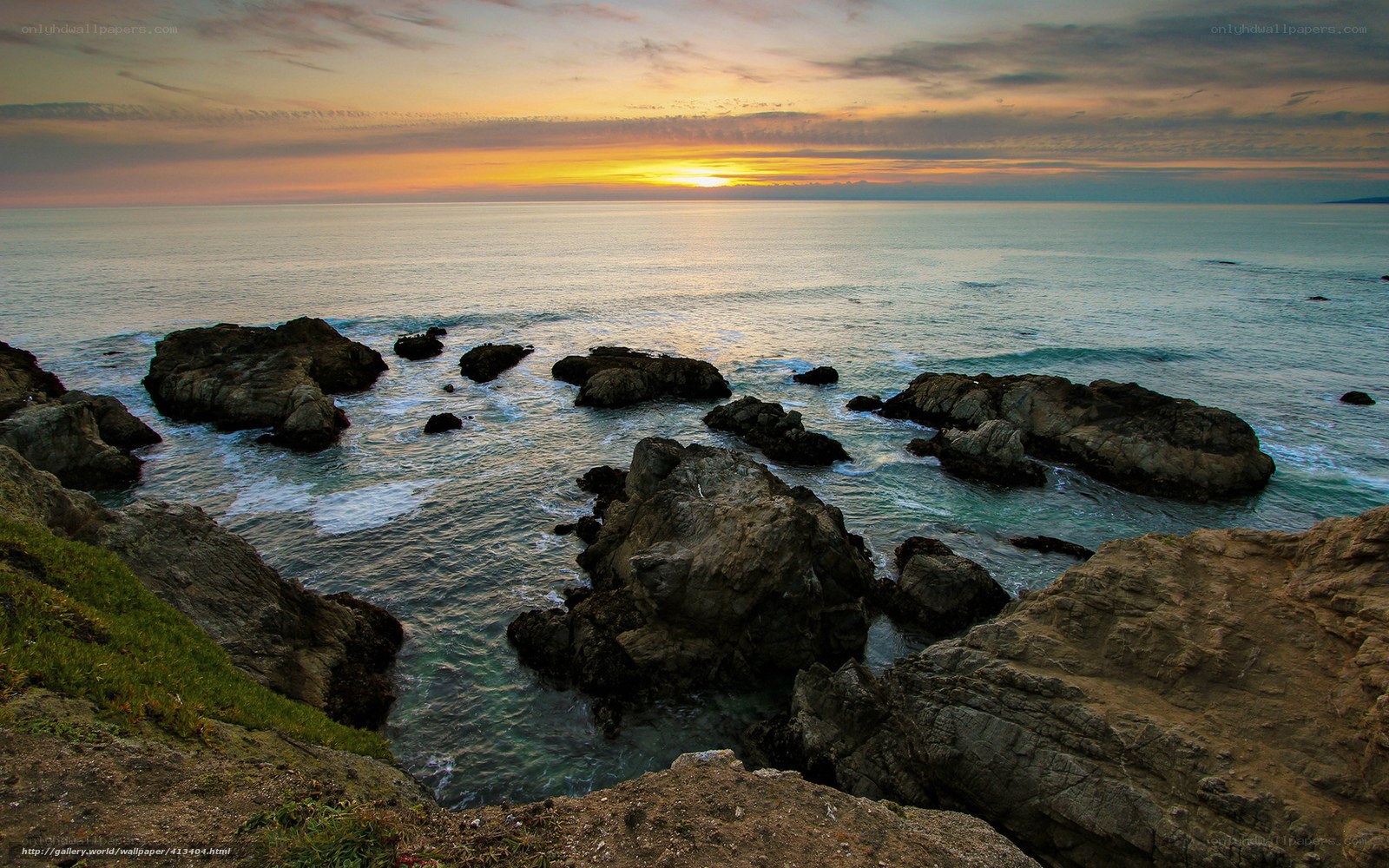 Sunset over rocky coastline