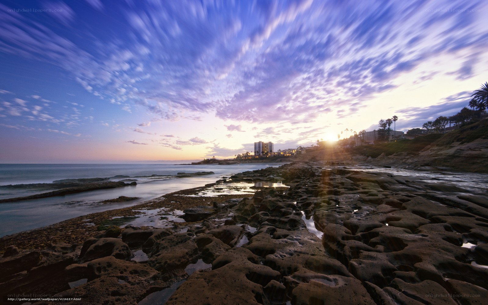 Sunset over rocky coastline