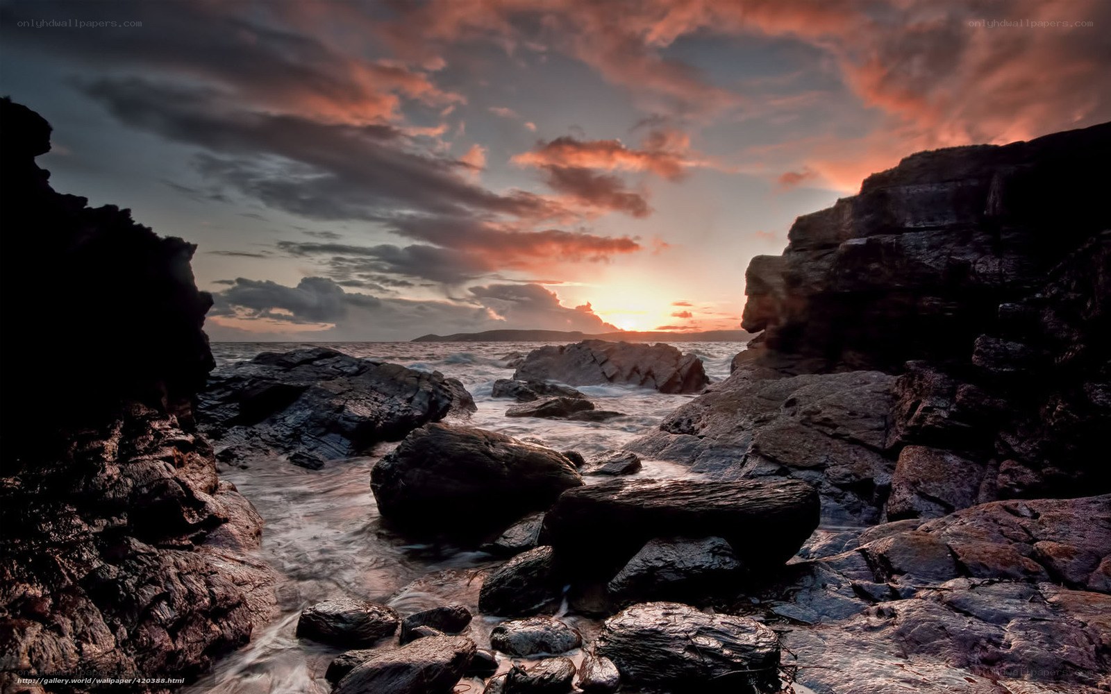 Sunset over rocky coastline