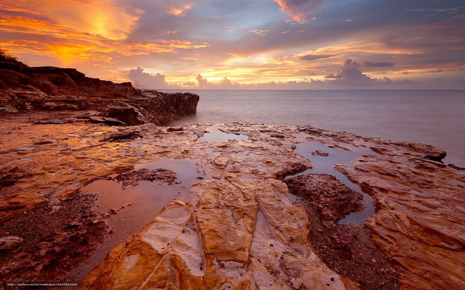 Sunset over rocky coastline