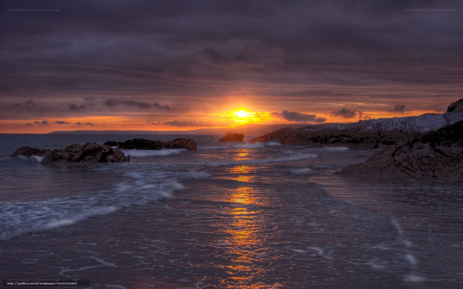 Sunset over rocky coastline