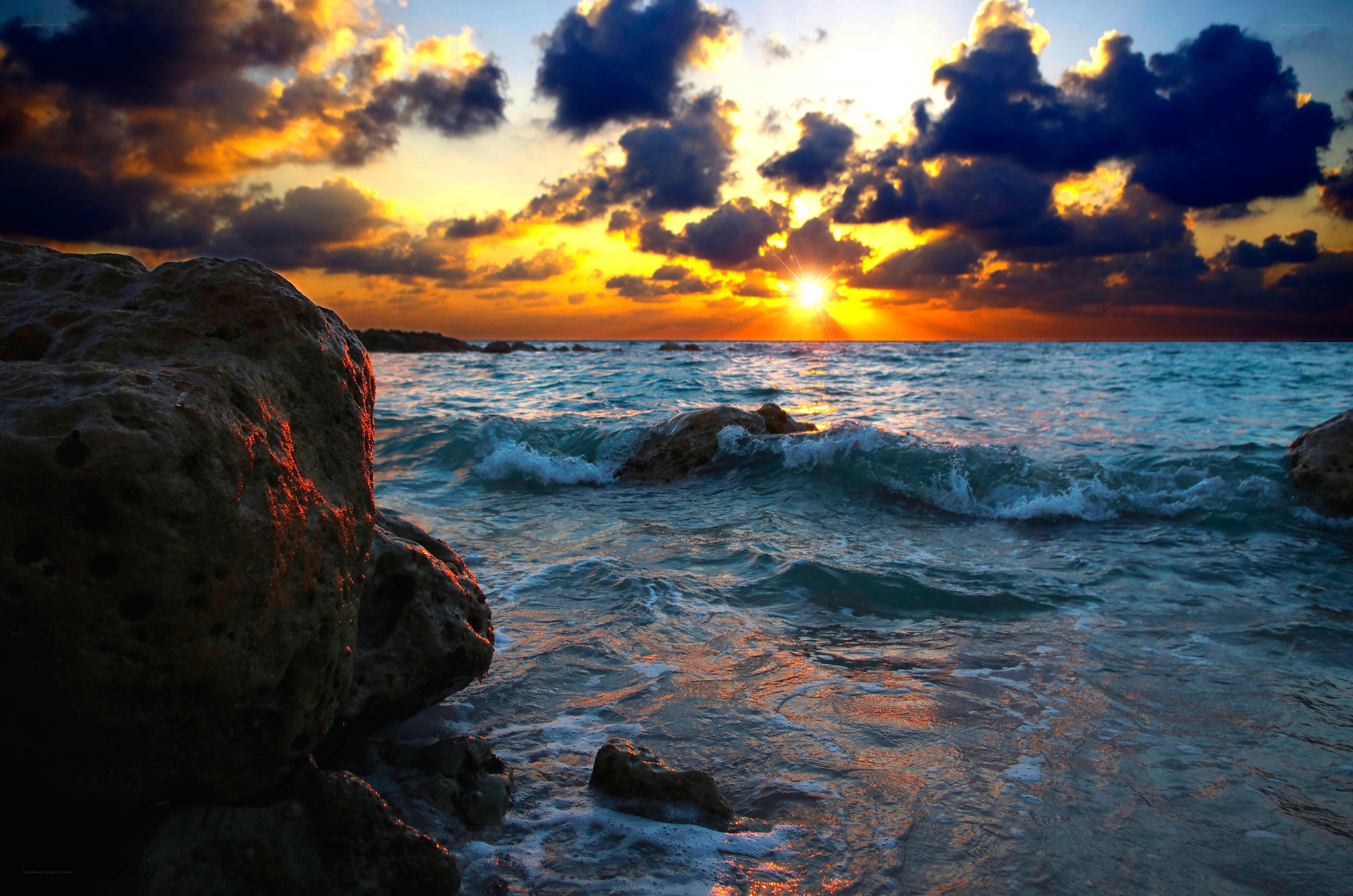 Sunset over rocky coastline