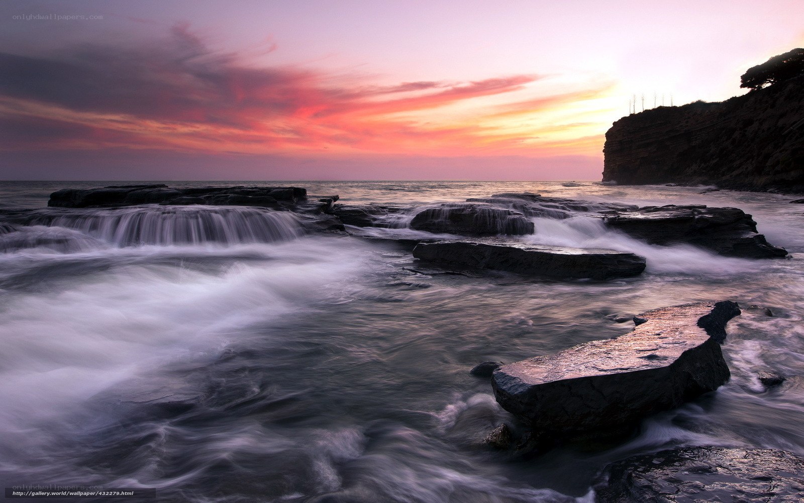 Sunset over rocky coastline