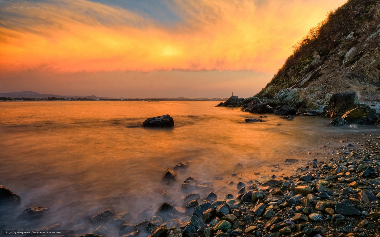 Sunset over rocky coastline