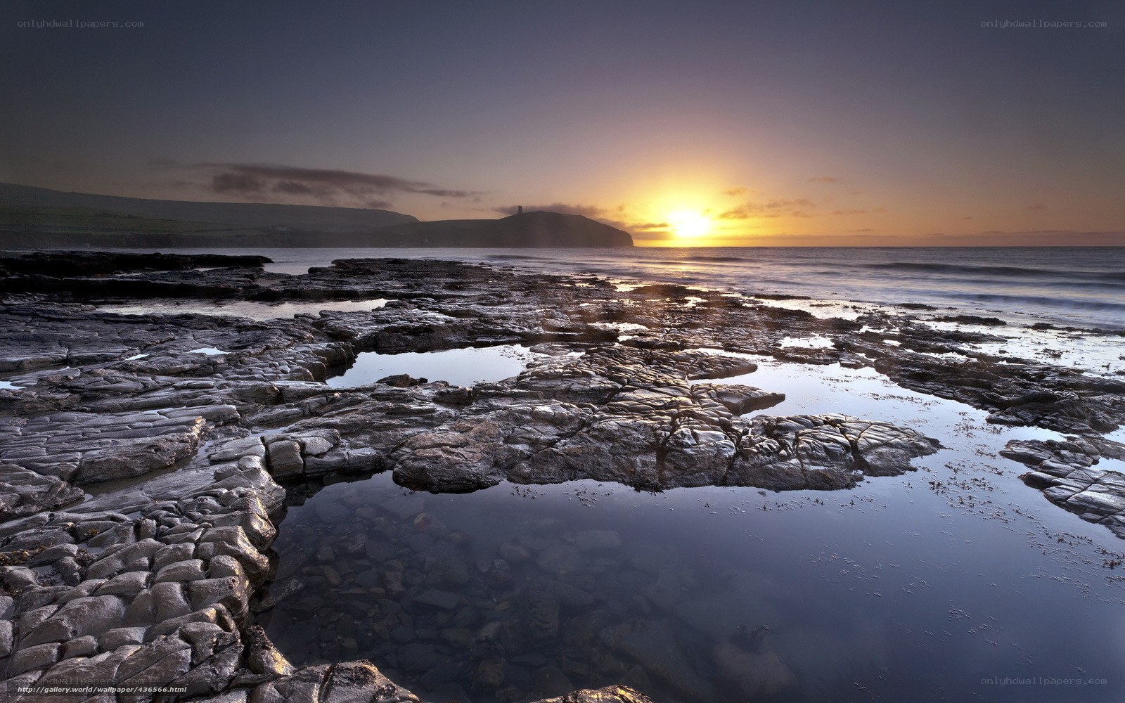 Sunset over rocky coastline