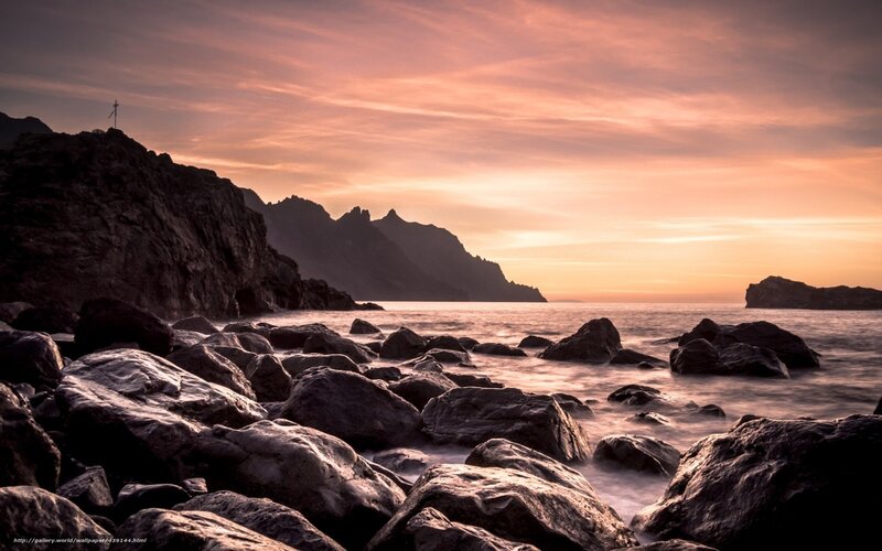 Sunset over rocky coastline