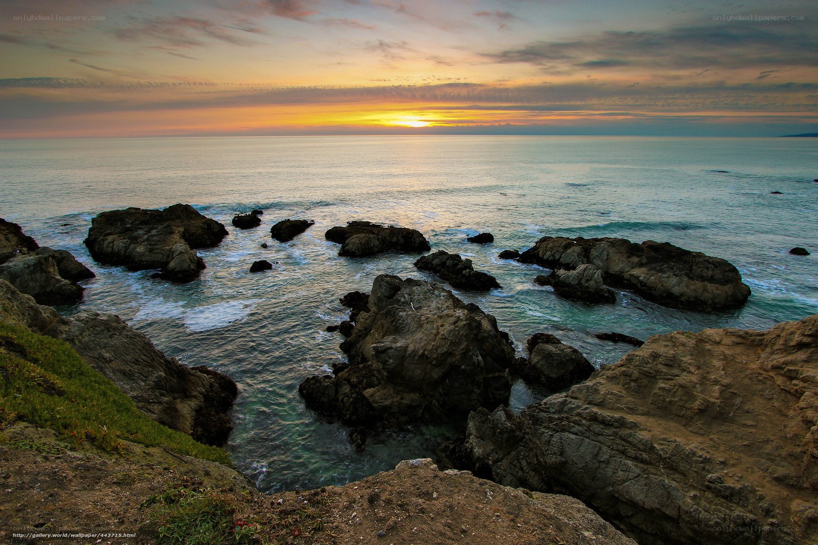 Sunset over rocky coastline