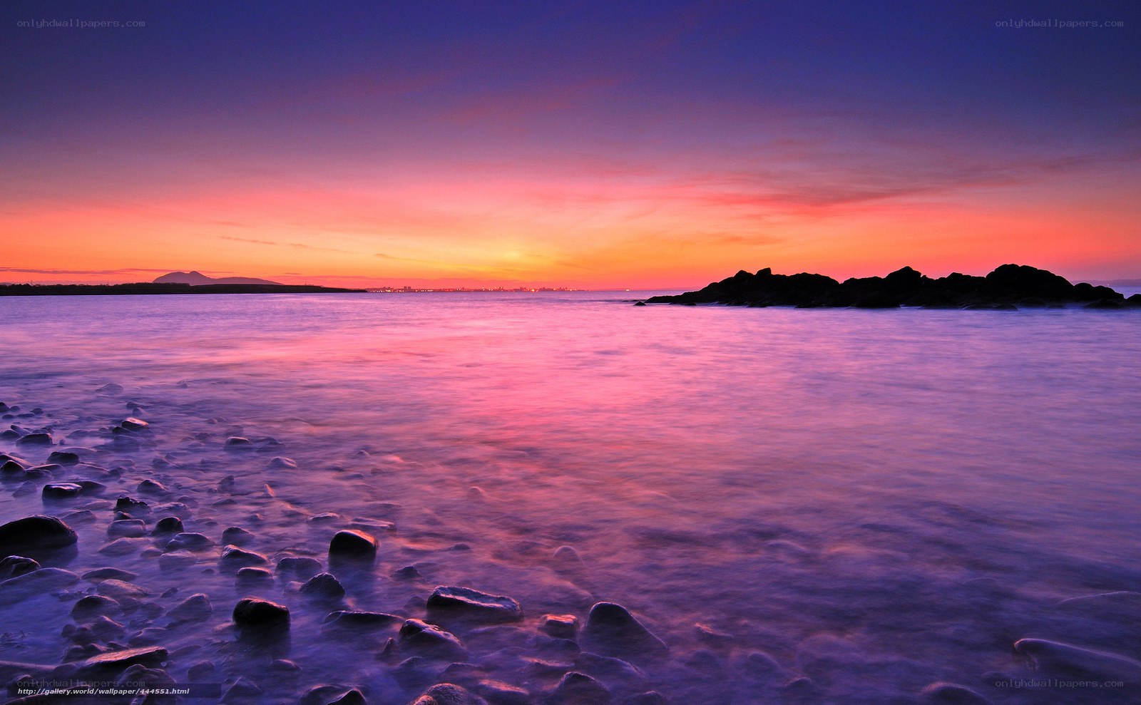 sunset over rocky coastline
