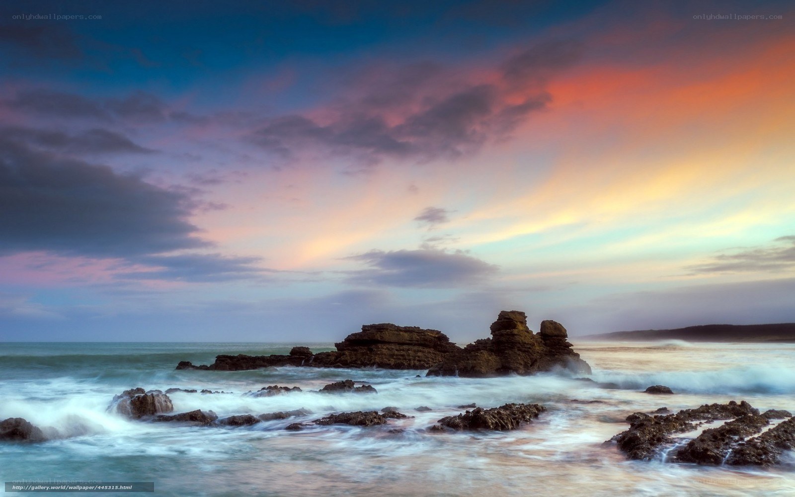 Sunset over rocky coastline